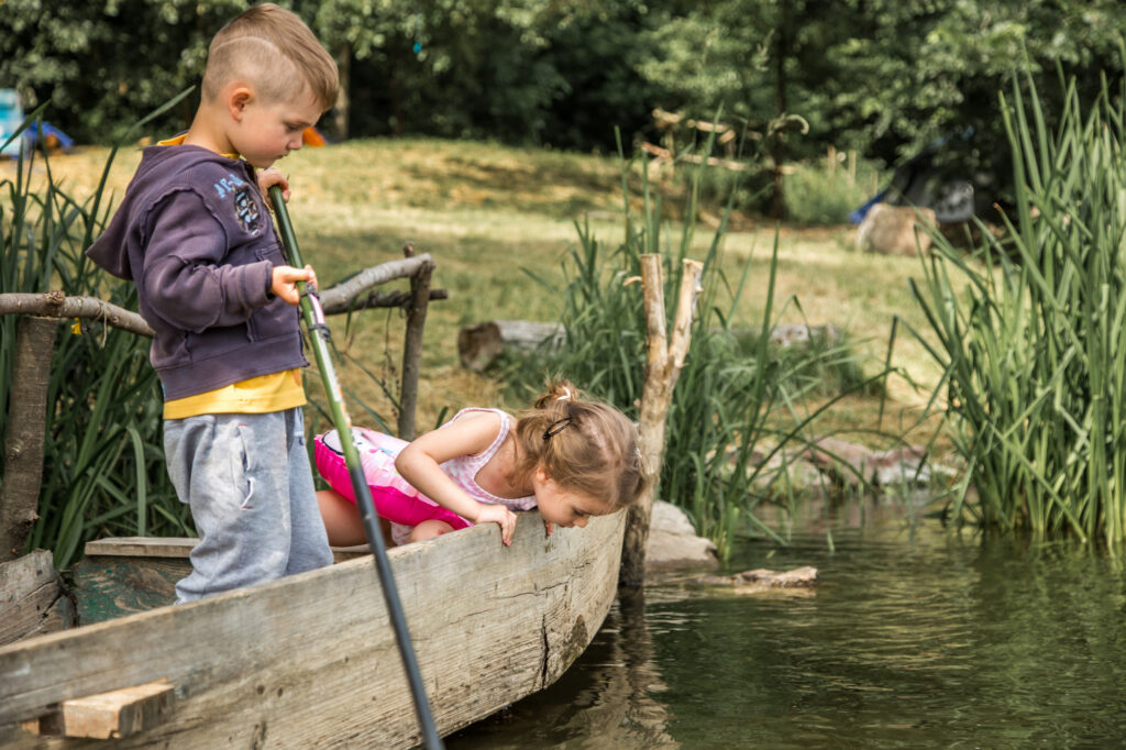 Children exploring the lake in Sabaudia in Circeo National Park enjoying outdoor family activities
