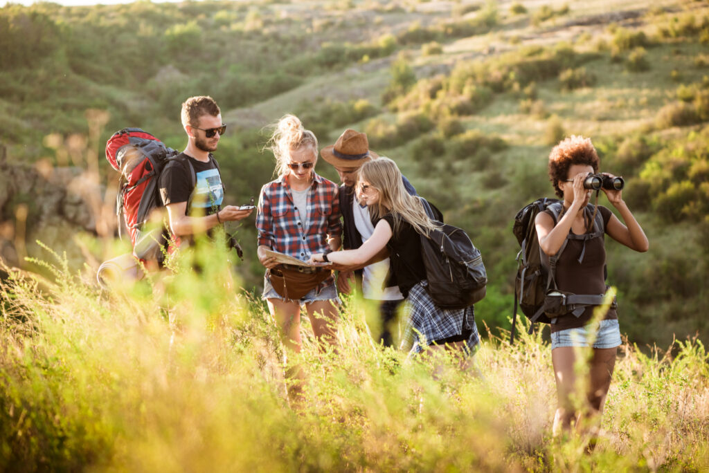 Group trekking and exploration in Circeo National Park near Sabaudia following a map in nature